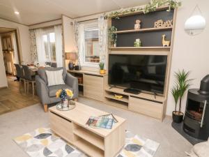 a living room with a large flat screen tv at Langdale Lodge in Carnforth