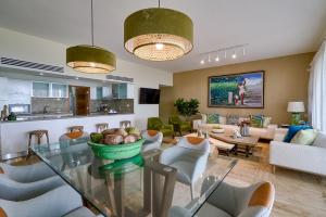 a living room with a table and chairs at Costa Atlantica Beach Condo in Punta Cana