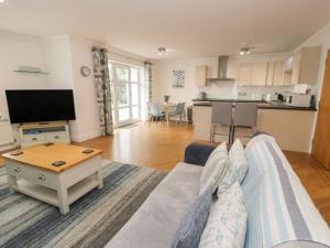 a living room with a couch and a table at Apartment 6 in Morfa Nefyn