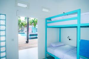 a bedroom with a bunk bed and a pool at Mad Monkey Kuta Lombok in Kuta Lombok
