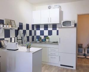 a kitchen with a white refrigerator and a microwave at gemütliches Appartament 30 m2 in Unna in Unna
