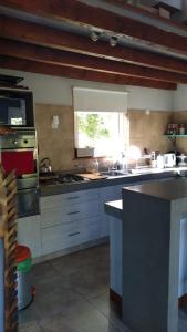 a kitchen with a sink and a stove top oven at Casa de montaña in San Carlos de Bariloche