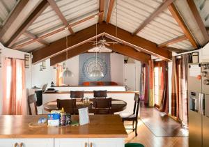 a kitchen and living room with a table and chairs at Sannyasa Wellness and Spa in Trou aux Biches