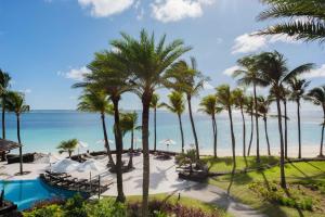 a beach filled with palm trees and palm trees at The Residence Mauritius in Belle Mare