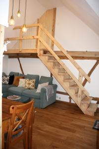 a living room with a loft bed and a couch at Wohnung Alter Heuboden im Fachwerk bei Bonn Alfter in Heidgen