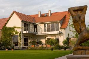 a house with an orange roof at Peeneblick - Traumhaus direkt am Wasser mit eigenem Bootssteg für 8 Personen in Rankwitz