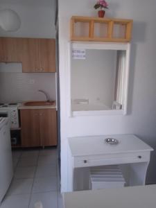 a kitchen with a white table and a window at Antonia Rooms in Skala Fourkas +32 photos