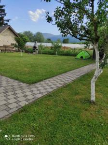 a green tent sitting in the middle of a yard at Meri rooms in Bihać