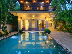 a house with a swimming pool in front of a house at My Key Polanka Pirvate Villa with Pool in Siem Reap