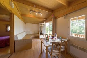 a room with a table and chairs and a bed at Domaine De Miraval in Belleserre