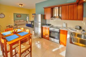 a kitchen with a table and a dining room at Naiades Summer House I in Plátanos