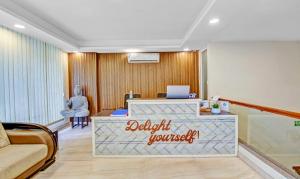 a hotel lobby with a reception desk with a laptop at Treebo Trend Sai Village Gold Souk - Sec 43 in Gurgaon