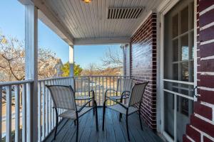 a porch with two chairs and a table on it at Summer Deal! Grand Performance Home in Downtown Fort Worth Stockyard, Globe Life, AT&T in Fort Worth