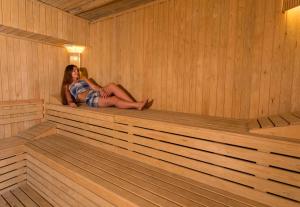 a woman is sitting in a sauna at CHARM BEACH HOTEL in Akyarlar
