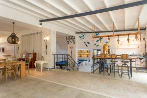 CHARM BEACH HOTEL في أكيارلار: غرفة معيشة مع طاولات وكراسي وغرفة طعام
