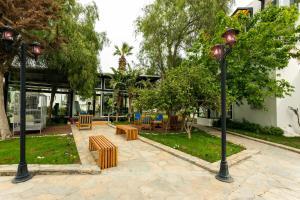 a park with two lights and tables and chairs at CHARM BEACH HOTEL in Akyarlar