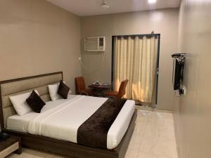Postel nebo postele na pokoji v ubytování Hotel Merakee - Near Dahisar Mira Road Mumbai