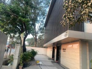 a dog is sitting outside of a building at Hotel Merakee - Near Dahisar Mira Road Mumbai in Mumbai