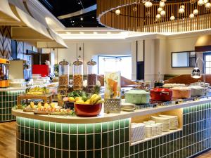 a buffet of food on a counter in a restaurant at ORIENTAL HOTEL UNIVERSAL CITY in Osaka