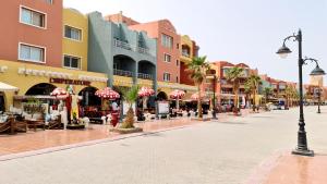 an empty street in a shopping center with stores at Rare New Marina Hotspot With Pool & Fast Free WIFI - Western Standards - Sheraton Plaza 415 in Hurghada