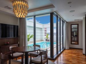 a dining room with a table and a view of a pool at Okinawa EXES Naha in Naha