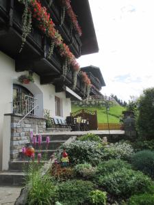 a house with flowers on the side of it at Haus Bergfried in Westendorf