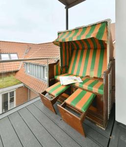 a pair of lounge chairs sitting on a deck at Ferienwohnung Sonnendüne Insel Juist in Juist