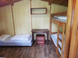 a room with two bunk beds and a desk at Sport kemp Ejpovice in Ejpovice