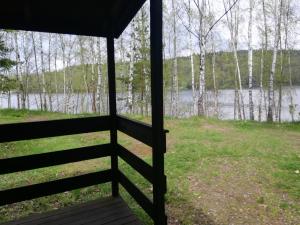 a view from the porch of a cabin overlooking a lake at Sport kemp Ejpovice in Ejpovice