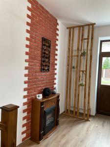 a living room with a brick wall and a fireplace at Norderney Apartments in Sibiu