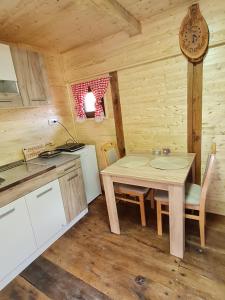 una cucina e una sala da pranzo con tavolo in una cabina di Taorska Vrela Apartman a Taor