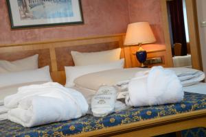 a bed with pillows and a blanket on top of it at The Monarch Hotel in Bad Gögging