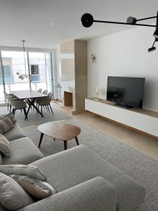 a living room with a couch and a table at Figueira Centro Apartment by Rent4All in Figueira da Foz
