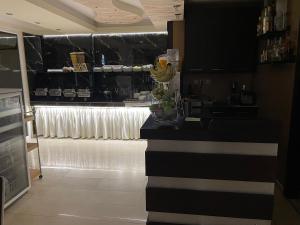a kitchen with a black counter and a window at Hotel San Antonio in Paralia Katerinis