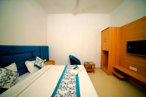 a hotel room with a bed and a tv at Hotel Diamond View in Amritsar