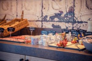 a buffet with plates of food on a table at Adagio Access Stuttgart Airport Messe in Leinfelden-Echterdingen
