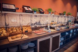 a buffet with bread and other food on a counter at Adagio Access Stuttgart Airport Messe in Leinfelden-Echterdingen