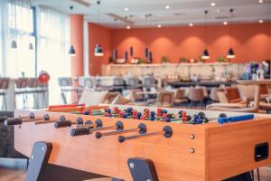 a wooden table with a chess board on top of it at Adagio Access Stuttgart Airport Messe in Leinfelden-Echterdingen