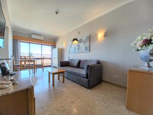 a living room with a couch and a table at OÁSIS Beach Apartment in Portimão