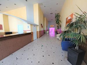 an empty lobby with plants in a building at OÁSIS Beach Apartment in Portimão