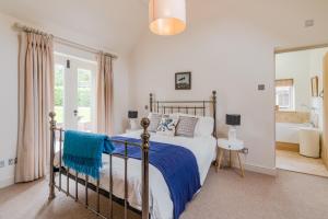 A bed or beds in a room at The Barn at Kington Grange