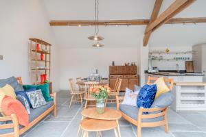 a living room with a couch and a table at The Barn at Kington Grange in Claverdon