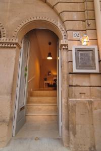 an entrance to a building with a door and stairs at Dedalo in Noto