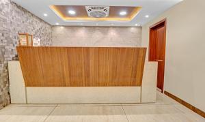 a reception desk in a lobby with a wooden partition at Itsy By Treebo - G Square in Vijayawāda
