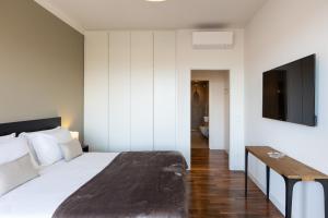 a bedroom with a bed and a flat screen tv at Amazing Via Parigi in Rome