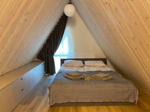 a bedroom with a bed in a attic at Sun&Sea in Palanga +2 photos