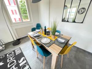 een eetkamer met een houten tafel en stoelen bij The 5 continents III - Premium appartment by Stay Swiss in Porrentruy +58 foto's