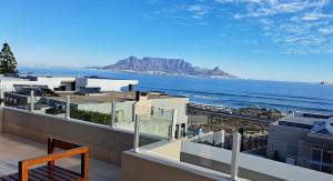 a view of the ocean from the balcony of a building at 2WhiteWaters Bloubergstrand Homestay in Bloubergstrand