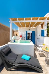 a bathtub in the middle of a patio at Seaside Breeze in Kamari