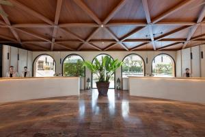 a large hall with a potted plant in the middle at Luna Club Hotel Yoga & Spa 4Sup in Malgrat de Mar +42 photos